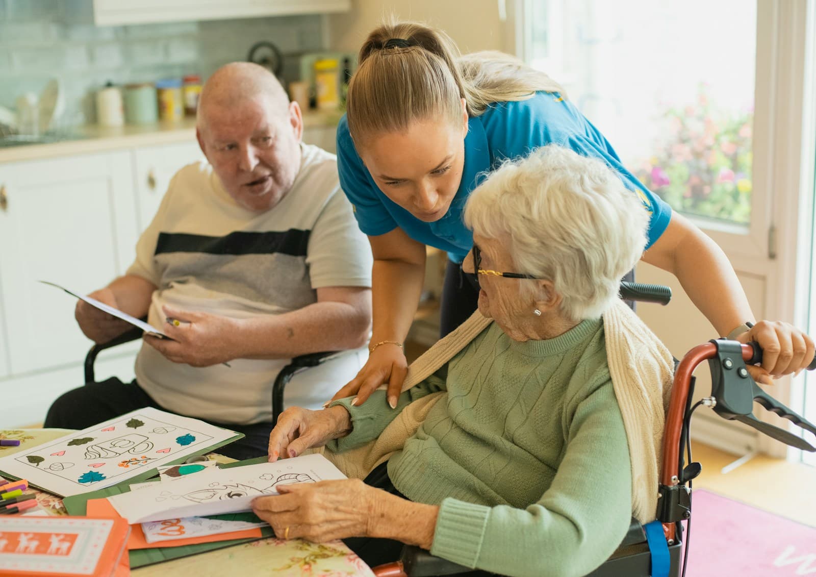 Caregiver supporting an elderly couple at home
